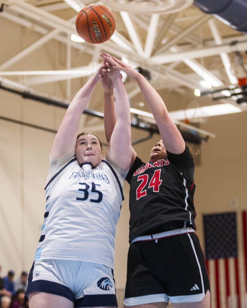 Meadowdale’s Audrey Lucas and Archbishop Murphy’s Celine Wright both leap in the air for a rebound during the game on Friday, Jan. 3, 2025 in Lynnwood, Washington. (Olivia Vanni / The Herald)
