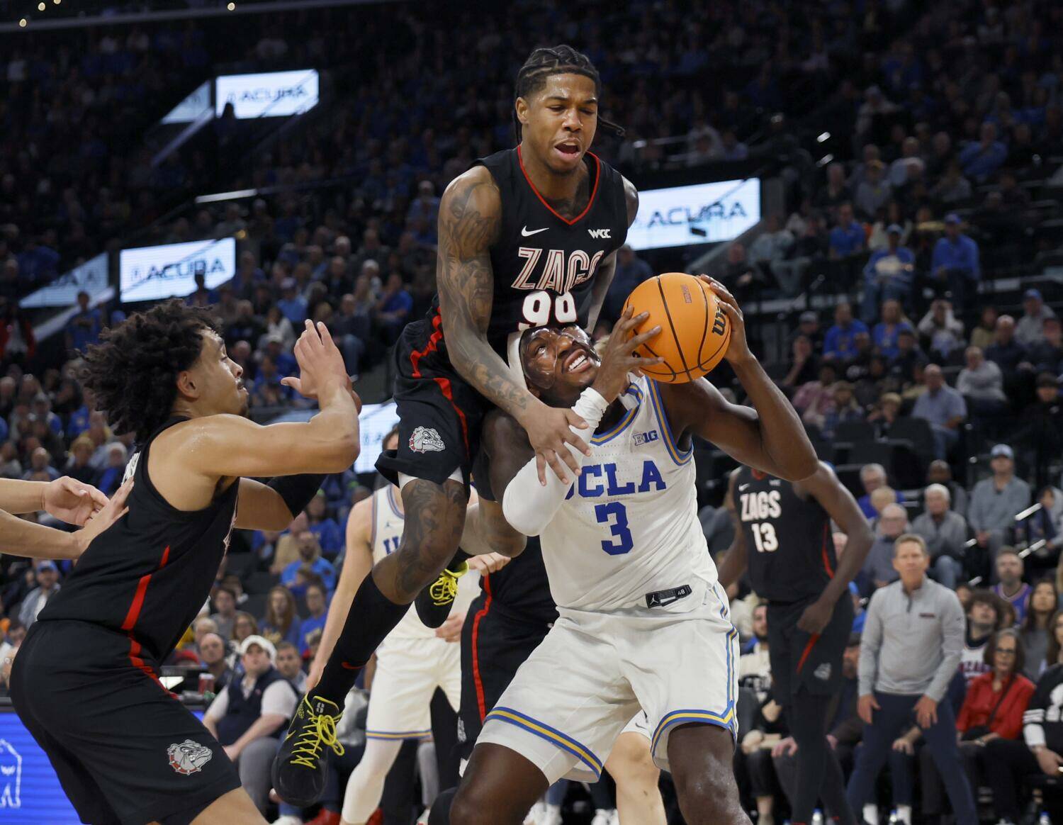 Inglewood, CA - December 28: Gonzaga guard Khalif Battle, center, #99, fouls UCLA guard/forward Eric Dailey Jr., #3, and was ejected from the game in the first half of the 2024 West Coast Hoops Showdown at the Intuit Dome in Inglewood Saturday, Dec. 28, 2024. (Allen J. Schaben / Los Angeles Times / Tribunes New Services)
