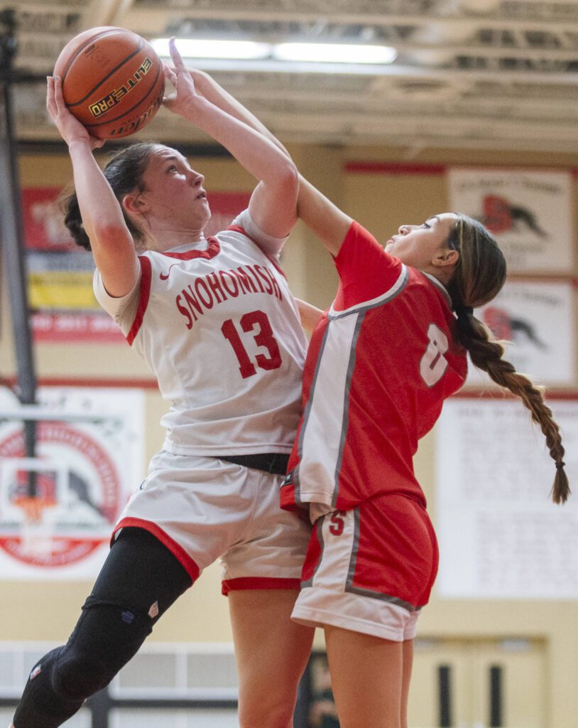Snohomish’s Sienna Capelli is fouled by Stanwood’s Georgia Lenz while trying to take a shot during the game on Thursday, Jan. 9, 2025 in Snohomish, Washington. (Olivia Vanni / The Herald)

