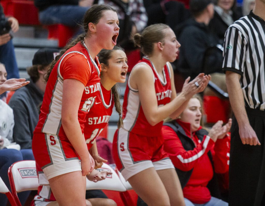 The Stanwood bench reacts to a three point shot during the game against Snohomish on Thursday, Jan. 9, 2025 in Snohomish, Washington. (Olivia Vanni / The Herald)
