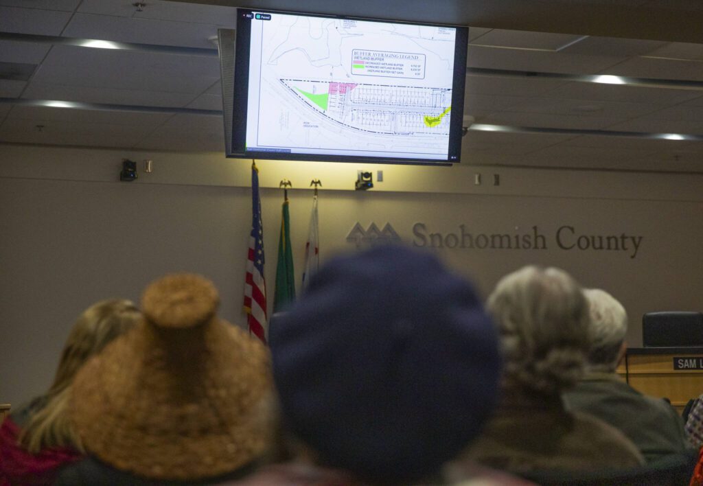 Map examples about wetland buffers and development are shown during a Snohomish County Council meeting addressing the proposed wetland ordinance amendments on Wednesday, Jan. 15, 2025 in Everett, Washington. (Olivia Vanni / The Herald)
