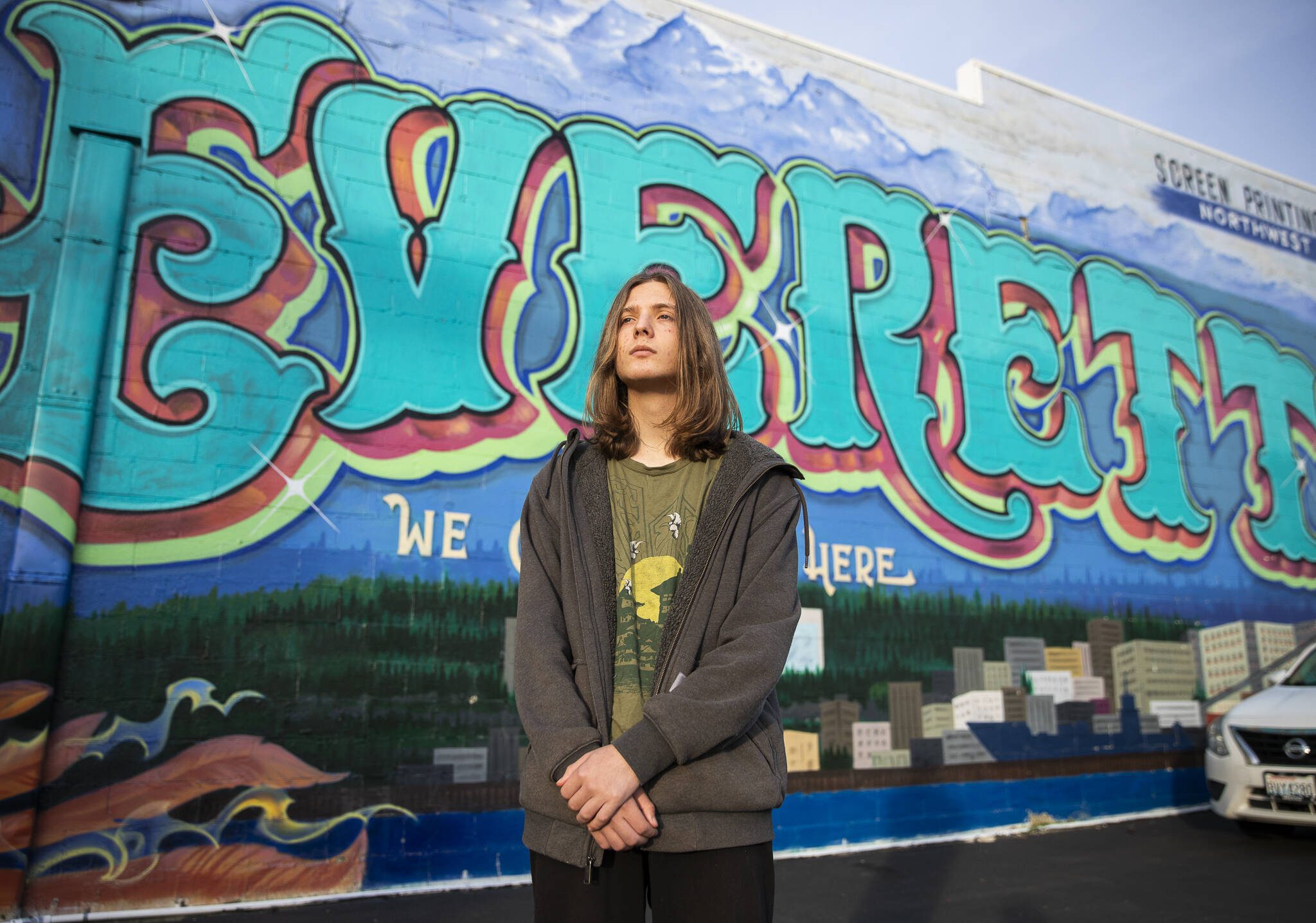 Everett P. Fog, 15, in front of an Everett mural along Colby Avenue in Everett. (Olivia Vanni / The Herald)