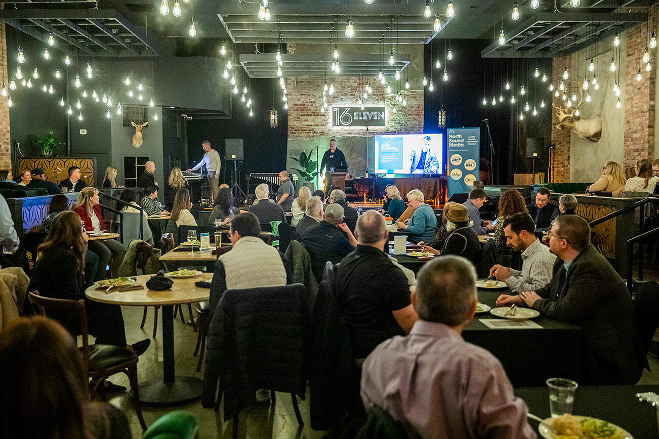 People listen to APEX founder John Carswell speak durning an Greater Everett Chamber of Commerce kick off event on Wednesday, Jan. 15, 2025 in Everett, Washington. (Olivia Vanni / The Herald)