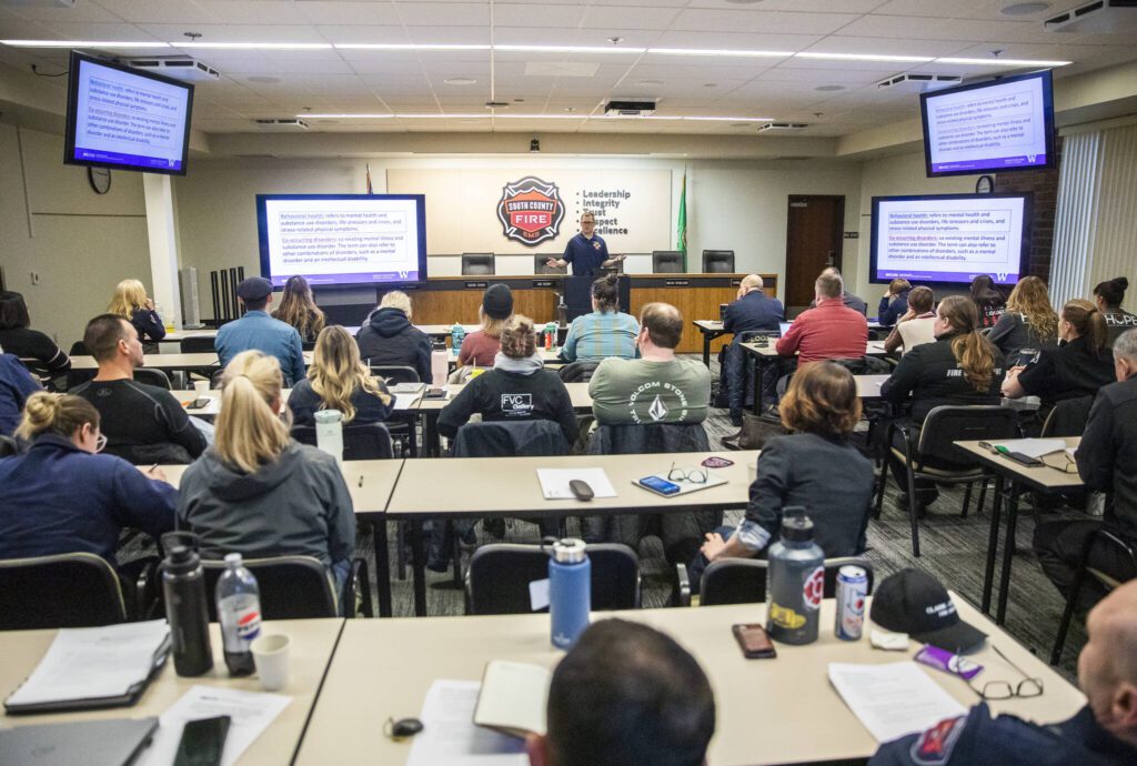 People listens as Alex McCracken, a paramedic with Kitsap Fire & Rescue, speaks about behavioral health calls during South County Fire’s behavioral health training on Friday, Jan. 17, 2025 in Everett, Washington. (Olivia Vanni / The Herald)
