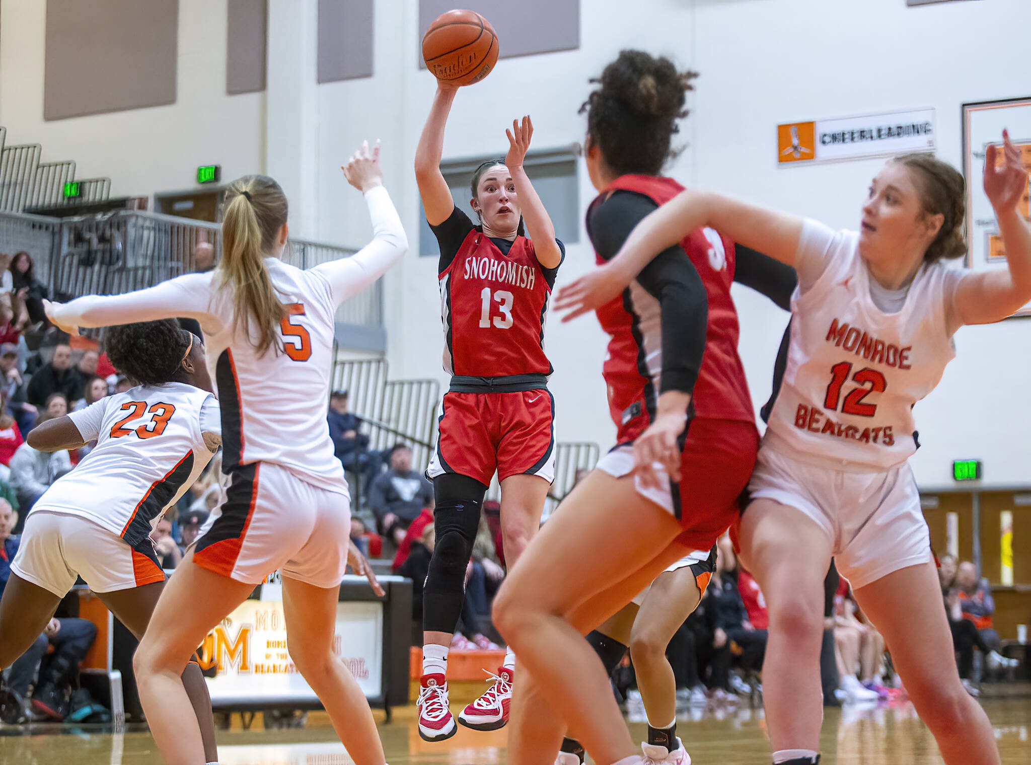 Snohomish’s Sienna Campelli leap in the air to try and pass the ball to teammate Tyler Gildersleeve-Stiles during the game on Wednesday, Jan. 15, 2025 in Monroe, Washington. (Olivia Vanni / The Herald)