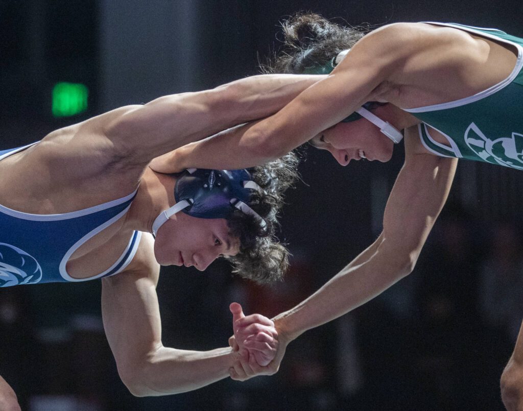 Edmonds-Woodway’s Aziret Bakytov and Meadowdale’s Lukah Washburn fight for hand positioning during the 126-pound match on Thursday, Jan. 16, 2025 in Edmonds, Washington. (Olivia Vanni / The Herald)
