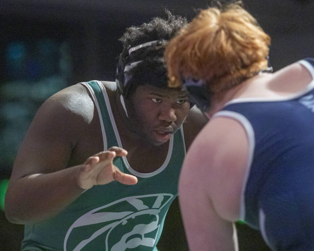 Edmonds-Woodway’s Edson Belizaire fights for hand positioning with Meadowdale’s Jaxson Hulbert during the 285-pound match on Thursday, Jan. 16, 2025 in Edmonds, Washington. (Olivia Vanni / The Herald)
