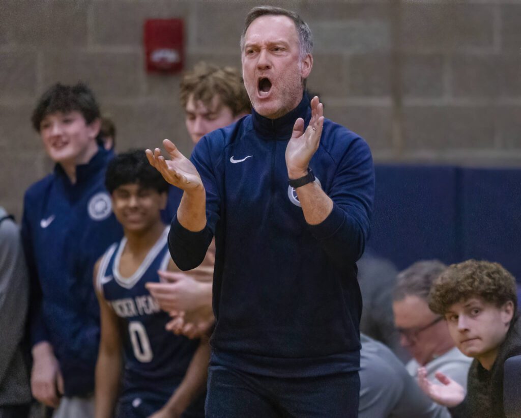 Glacier Peak head coach Brian Hunter yells in celebration after a three point shot during the game against Arlington on Friday, Jan. 17, 2025 in Arlington, Washington. (Olivia Vanni / The Herald)
