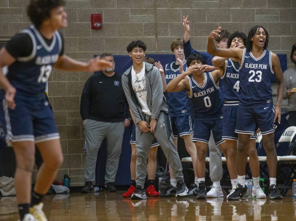 The Glacier Peak bench reacts to a three point shot during the game against Arlington on Friday, Jan. 17, 2025 in Arlington, Washington. (Olivia Vanni / The Herald)
