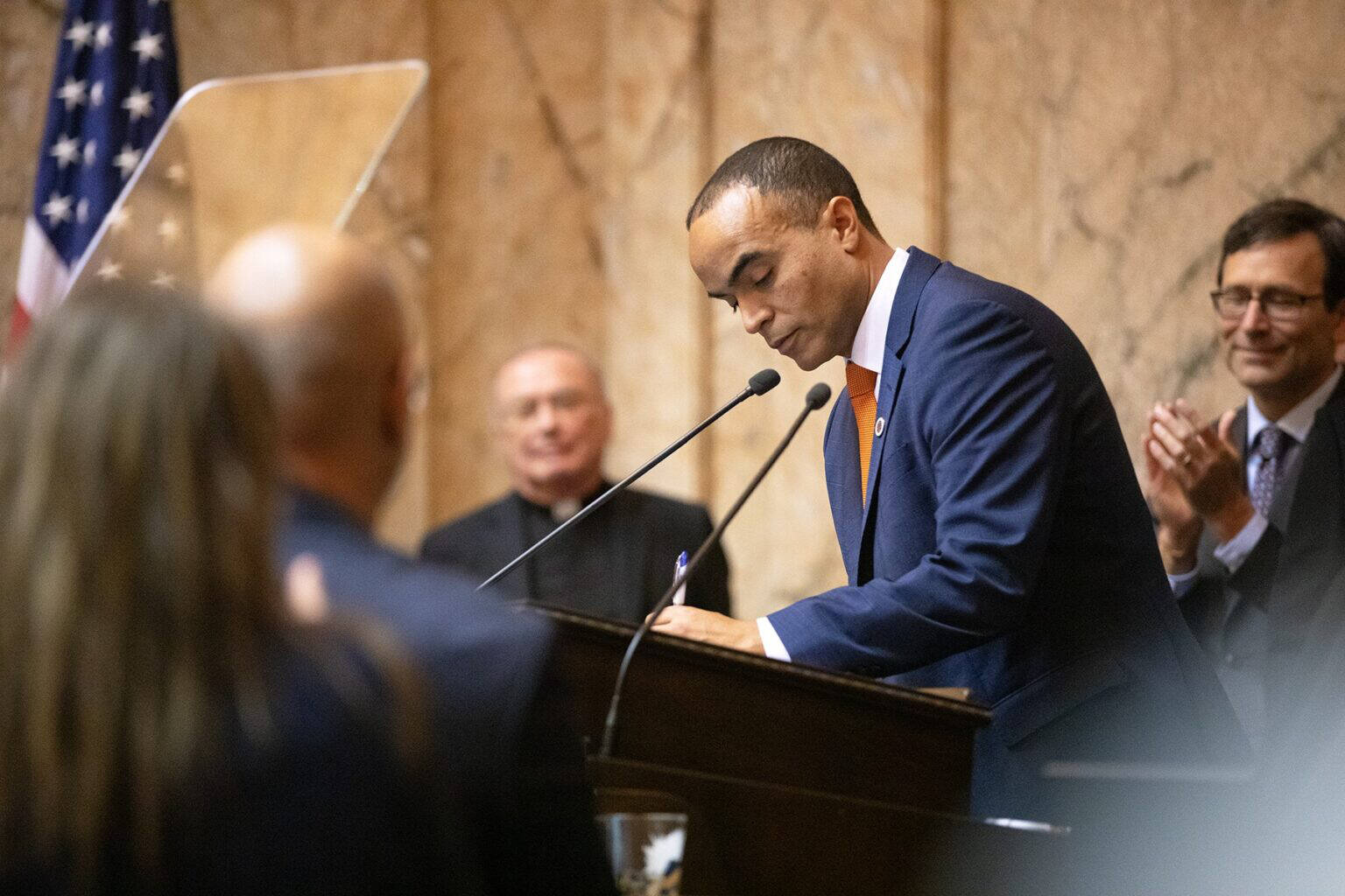 Attorney General Nick Brown signs his election certificate after being sworn in Wednesday at the Washington State Capitol in Olympia. (Ryan Berry/Washington State Standard)