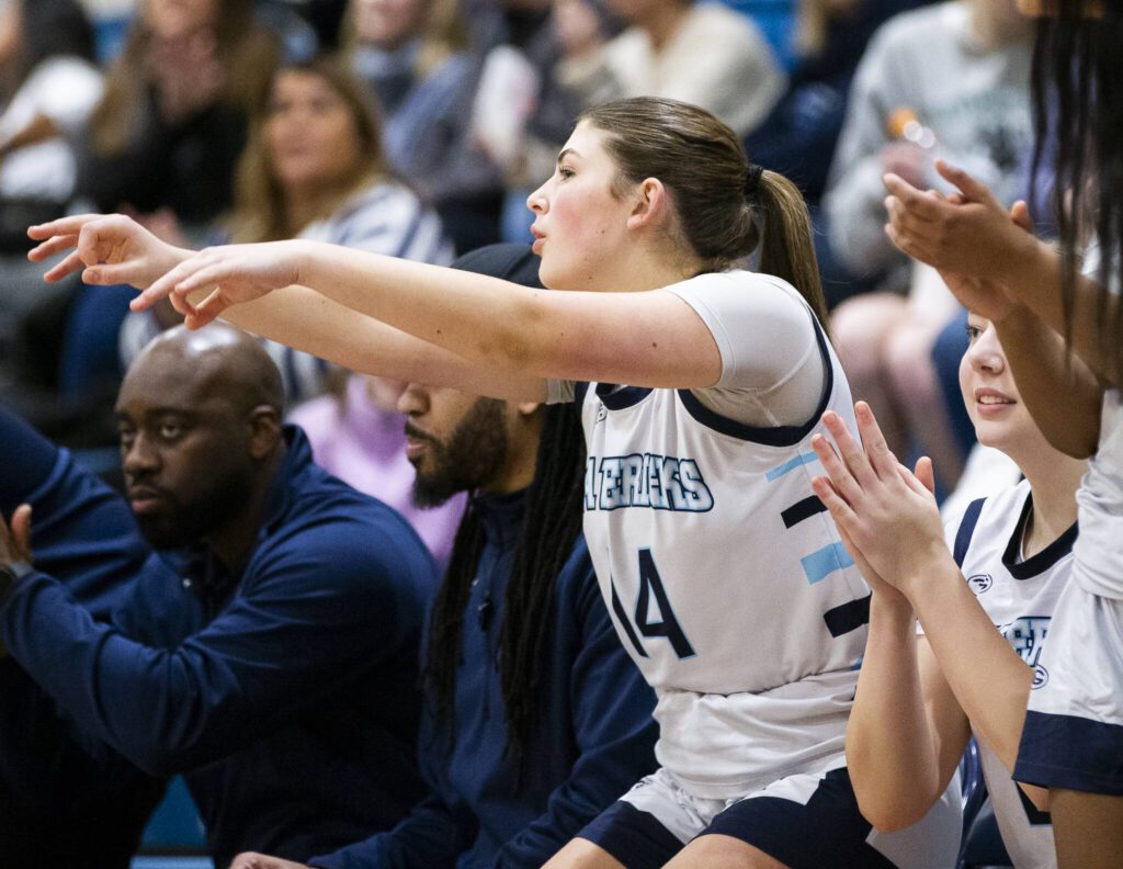 Meadowdale’s Kaya Powell puts three finger in the air in celebration of a teammates three point shot during the game against Shorewood on Wednesday, Jan. 22, 2025 in Lynnwood, Washington. (Olivia Vanni / The Herald)
