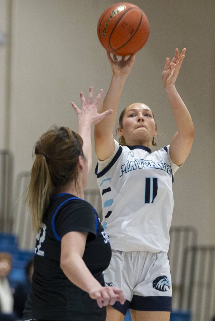 Meadowdale’s Mia Brockmeyer makes a three point shot during the game against Shorewood on Wednesday, Jan. 22, 2025 in Lynnwood, Washington. (Olivia Vanni / The Herald)
