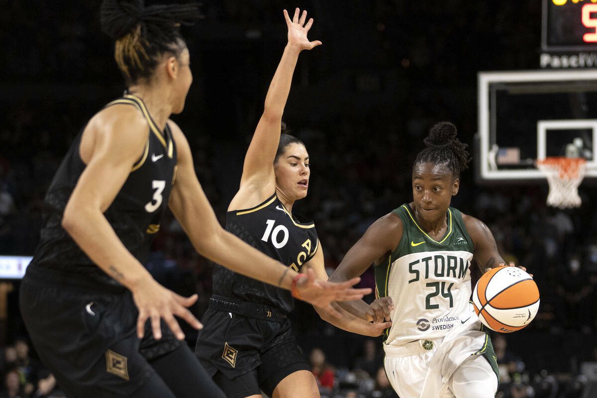 Seattle Storm guard Jewell Loyd (24) dribbles around Las Vegas Aces guard Kelsey Plum (10) while Aces forward Candace Parker (3) prepares to defend during the first half of a WNBA basketball game at Michelob ULTRA Arena on Thursday, June 15, 2023, in Las Vegas. (Ellen Schmidt / Las Vegas Review-Journal / Tribune News Services)