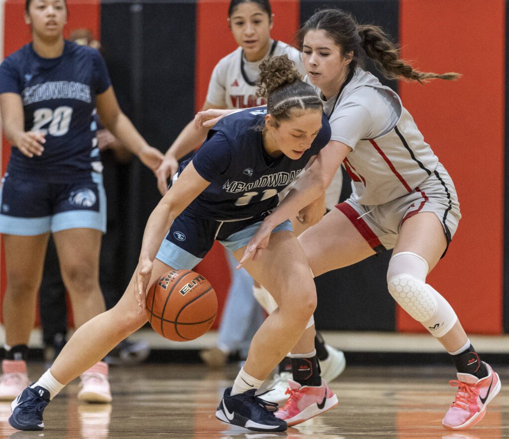 Archbishop Murphy’s Ava Marr tries to knock the ball away from Meadowdale’s Mia Brockmeyer during the game on Thursday, Jan. 30, 2025 in Everett, Washington. (Olivia Vanni / The Herald)
