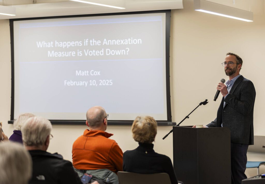 Edmonds resident Matt Cox makes a presentation on his research to those gathered for an Edmonds Civic Roundtable event discussing the RFA annexation vote on Monday, Feb. 10, 2025 in Edmonds, Washington. (Olivia Vanni / The Herald)
