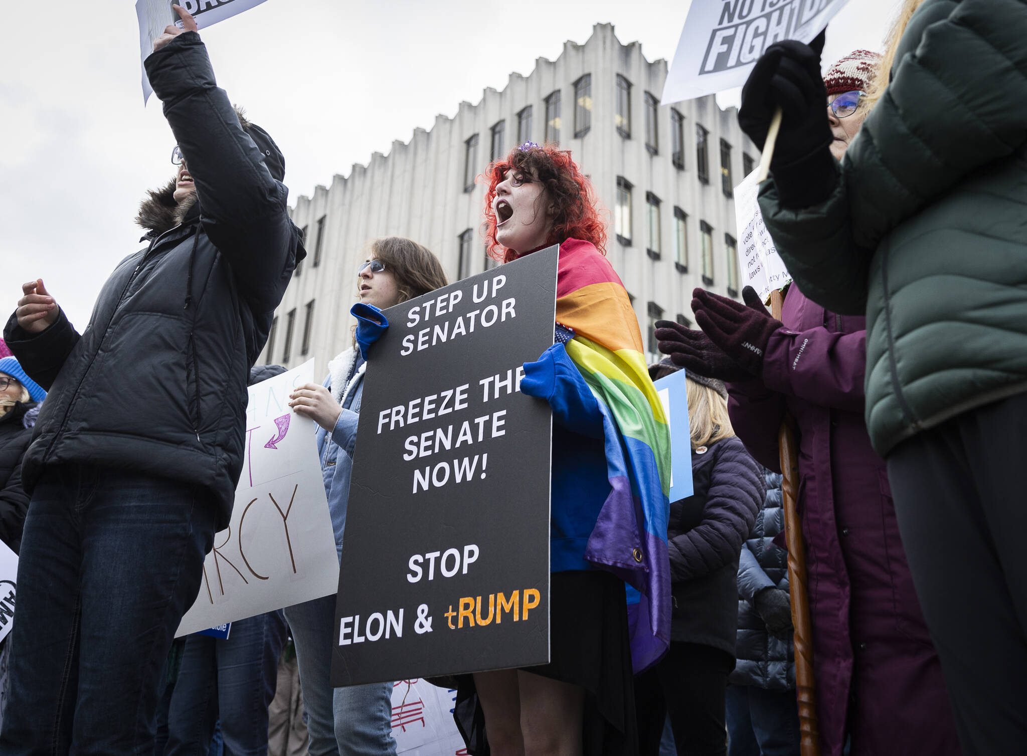 Ari Smith, 14, cheers in agreement with one of the speakers during a rally organized by Snohomish County Indivisible at the Snohomish County Campus on Wednesday, Feb. 5, 2025, in Everett, Washington. (Olivia Vanni / The Herald)