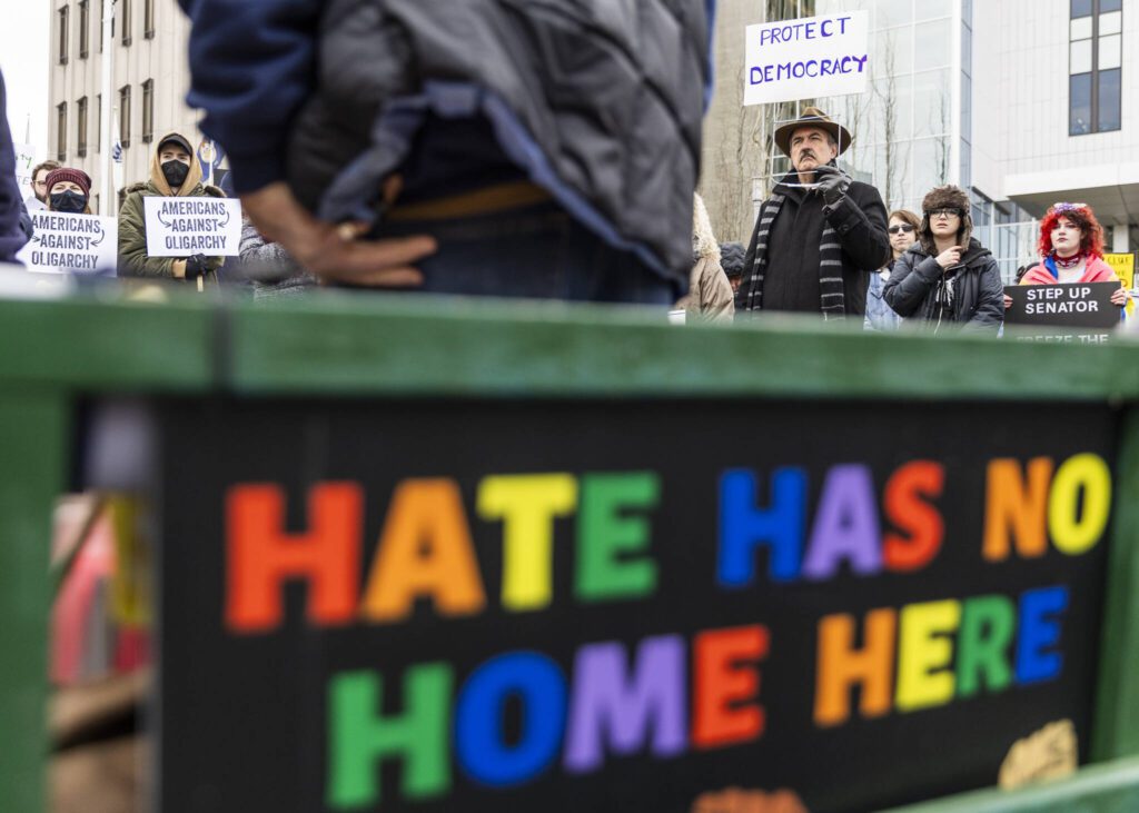 People listen to speakers during a rally organized by Snohomish County Indivisible at the Snohomish County Campus on Wednesday, Feb. 5, 2025 in Everett, Washington. (Olivia Vanni / The Herald)
