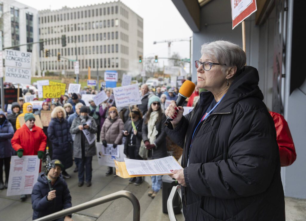 Founder of Snohomish County Indivisible Naomi Dietrich speaks to those gathered for the rally on Wednesday, Feb. 5, 2025 in Everett, Washington. (Olivia Vanni / The Herald)
