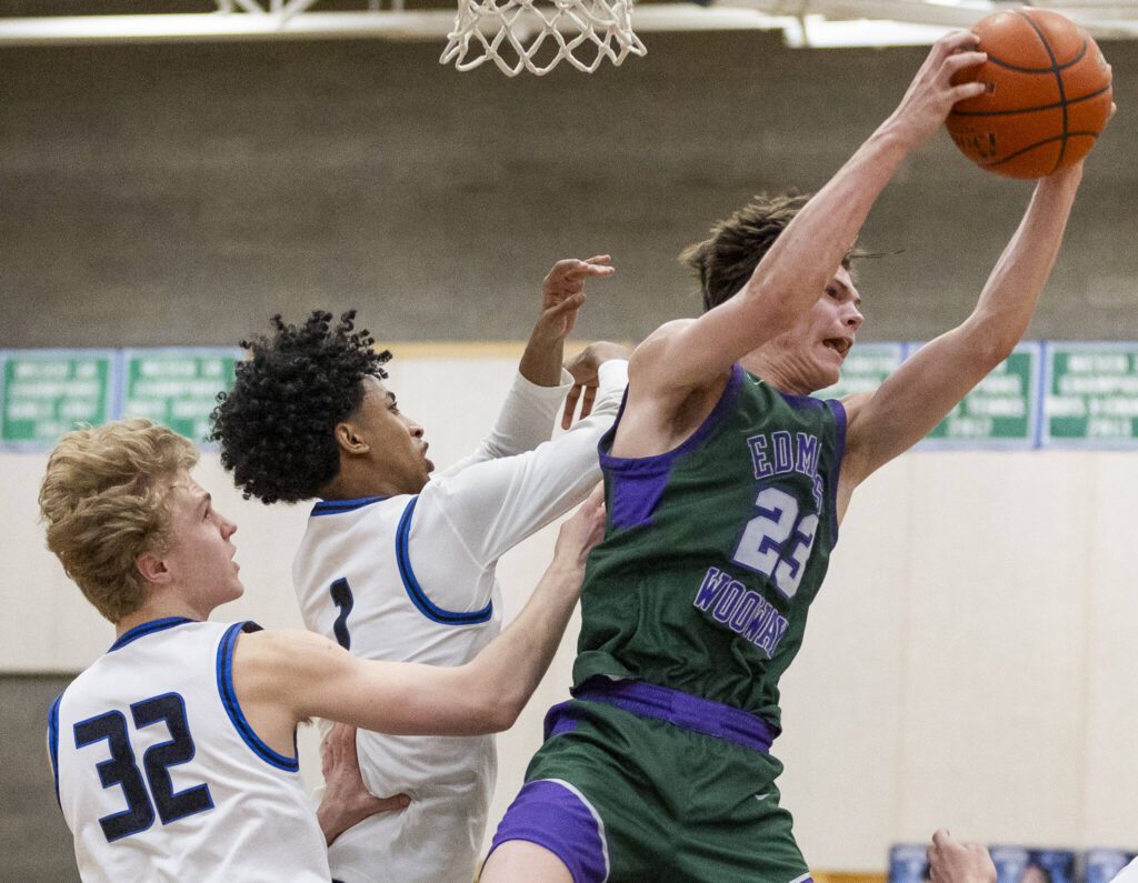 Edmonds-Woodway’s DJ Karl leaps in the air to make a rebound during the game against Shorewood on Tuesday, Feb. 4, 2025 in Shoreline, Washington. (Olivia Vanni / The Herald)
