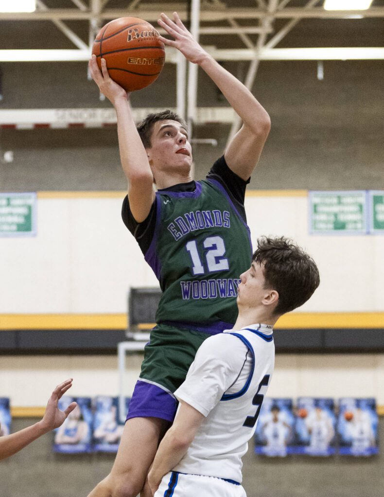 Edmonds-Woodway’s William Alseth makes a jump shot over the top of Shorewood’s Thomas Moles during the game on Tuesday, Feb. 4, 2025 in Shoreline, Washington. (Olivia Vanni / The Herald)
