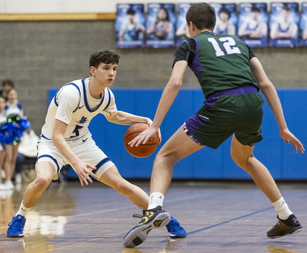 Shorewood’s Thomas Moles tries to dribble around Edmonds-Woodway’s William Alseth during the game on Tuesday, Feb. 4, 2025 in Shoreline, Washington. (Olivia Vanni / The Herald)
