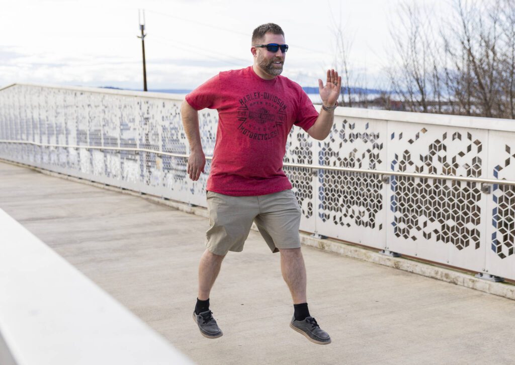 Jake Myers on the Grand Avenue Park pedestrian bridge on Feb. 18 in Everett. (Olivia Vanni / The Herald)
