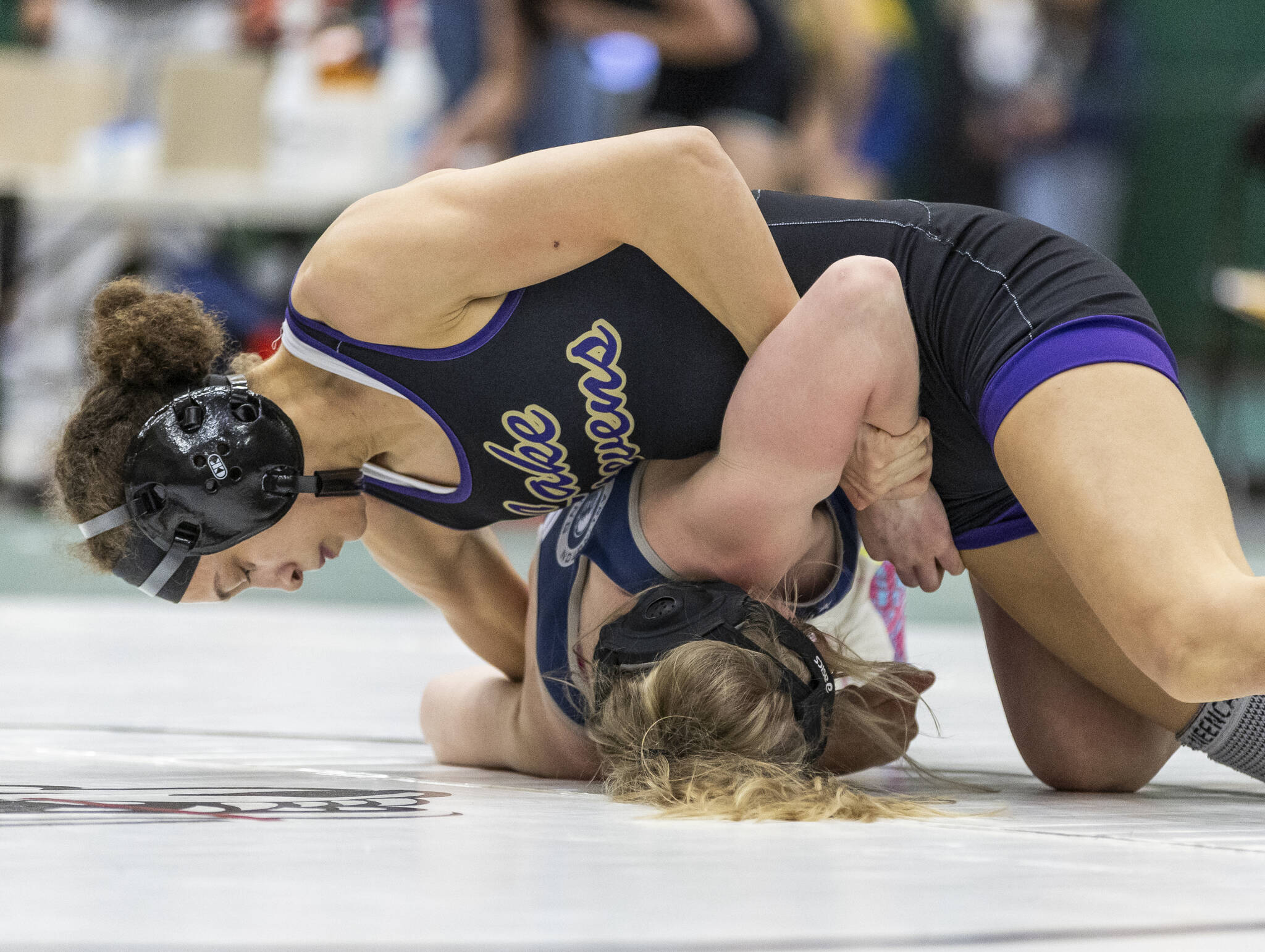 Lake Stevens’ Kamryn Mason attempts to flip Glacier Peak’s Kyla Brown onto her back during 110-pound match at the 4A girls wrestling district tournament on Friday, Feb. 7, 2025 in Mill Creek, Washington. (Olivia Vanni / The Herald)