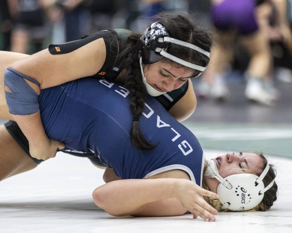 Jackson’s Emily Ortiz Marquez tries to push down on Glacier Peak’s Marissa Denke as she tries to lift her back up off of the mat during the 145-pound match at the 4A girls wrestling district tournament on Friday, Feb. 7, 2025 in Mill Creek, Washington. (Olivia Vanni / The Herald)
