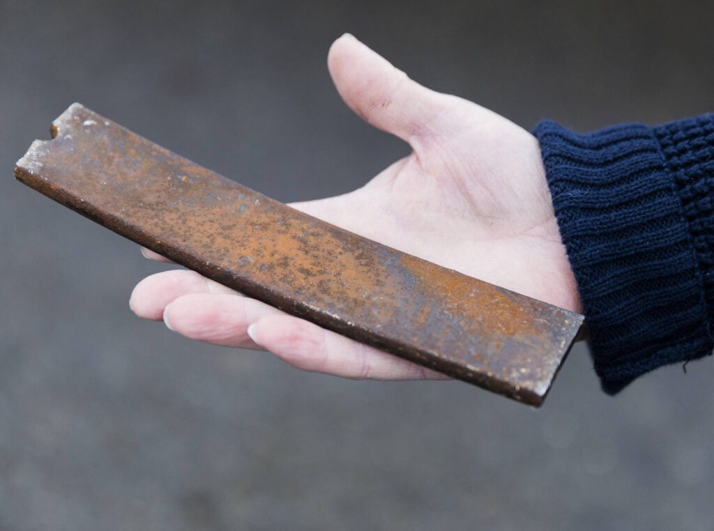 O’Leary shows the piece of metal that flew through the driver’s side windshield of his bus on Friday, Feb. 14, 2025 in Bothell, Washington. (Olivia Vanni / The Herald)
