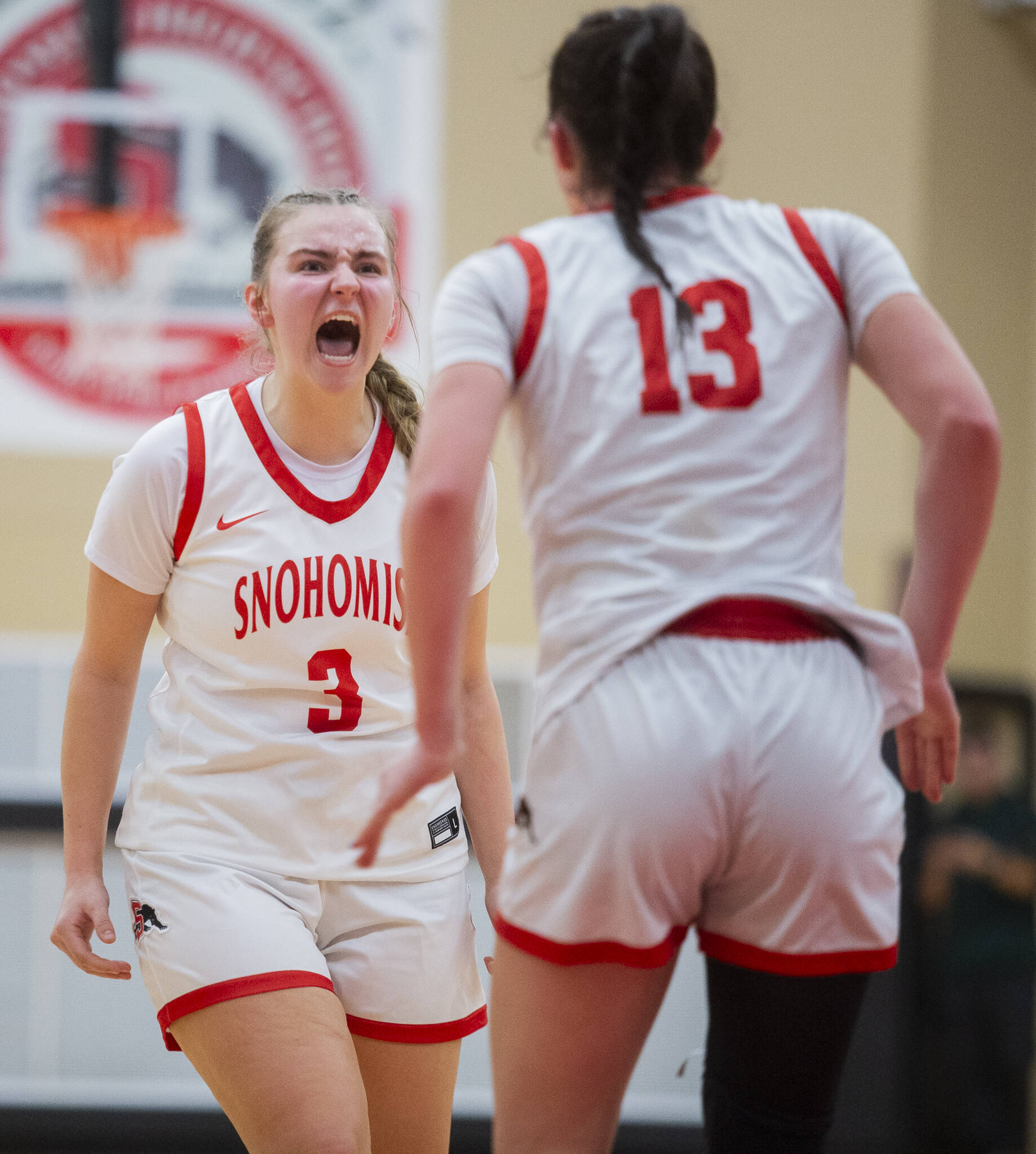 Snohomish’s Kendall Hammer yells in celebration with teammate Snohomish’s Sienna Capelli after she makes a shot and is fouled during the game on Thursday, Jan. 9, 2025 in Snohomish, Washington. (Olivia Vanni / The Herald)