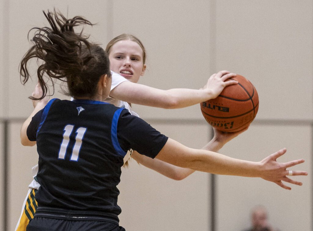 Shorecrest’s Jorja Perrin tries to the keep the ball away from Shorewood’s Bridget Cox during the 3A district playoff game on Friday, Feb. 14, 2025 in Shoreline, Washington. (Olivia Vanni / The Herald)
