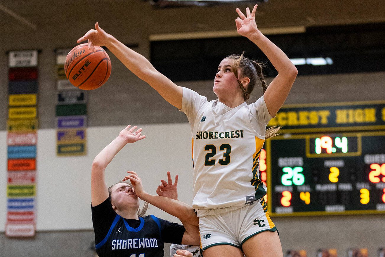 Shorecrest’s Cassie Chesnut leaps in the air to block a shot by Shorewood’s Bridget Cox during the 3A district playoff game on Friday, Feb. 14, 2025 in Shoreline, Washington. (Olivia Vanni / The Herald)