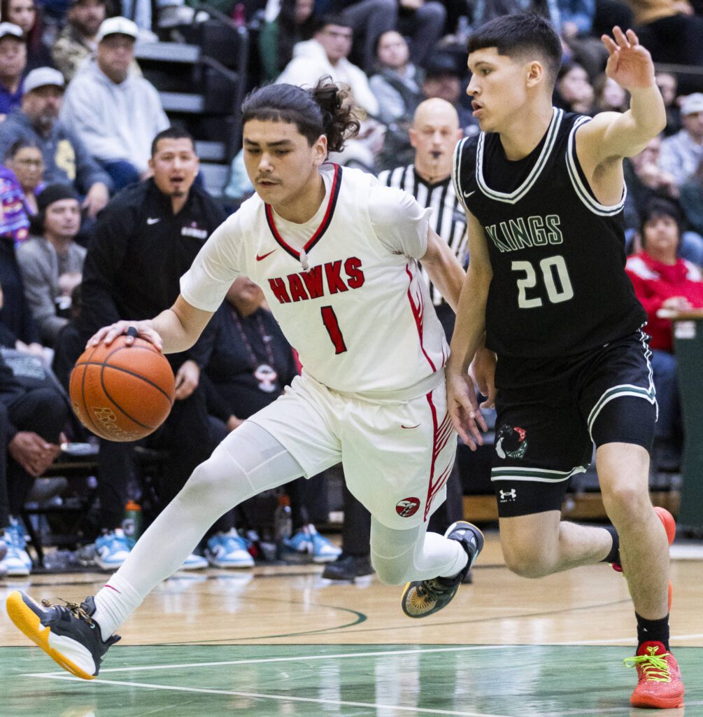 Tulalip Heritage’s Amare’ Hatch tries to dribble around Muckleshoot’s Rylee Markantonatos during the winner-to-state playoff game against Muckleshoot Tribal School on Tuesday, Feb. 18, 2025 in Marysville, Washington. (Olivia Vanni / The Herald)
