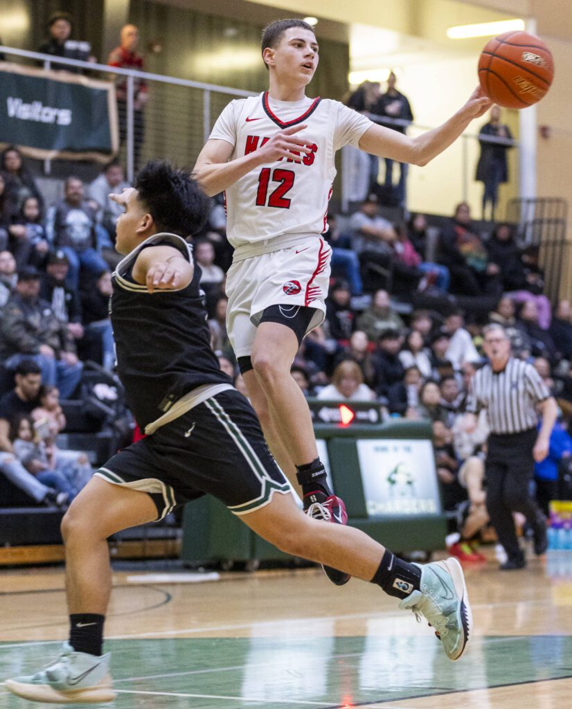 Tulalip Heritage’s Davis Bachand leaps in the air to pass the ball during the winner-to-state playoff game against Muckleshoot Tribal School on Tuesday, Feb. 18, 2025 in Marysville, Washington. (Olivia Vanni / The Herald)
