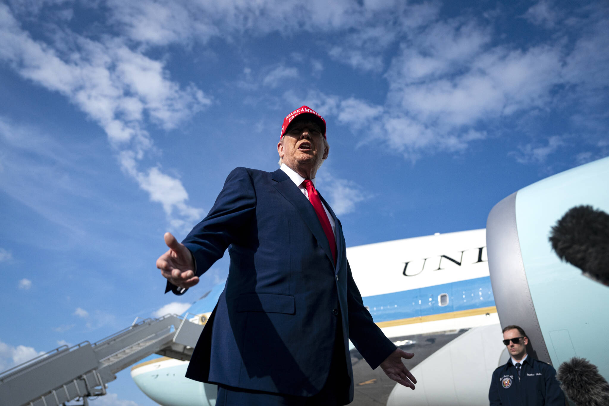 President Donald Trump speaks to reporters at Palm Beach International Airport in West Palm Beach, Fla., on Sunday. Trump, furious about delays in delivering two new Air Force One jets, has empowered Elon Musk to explore drastic options to prod Boeing to move faster, including relaxing security clearance standards. (Al Drago/The New York Times)