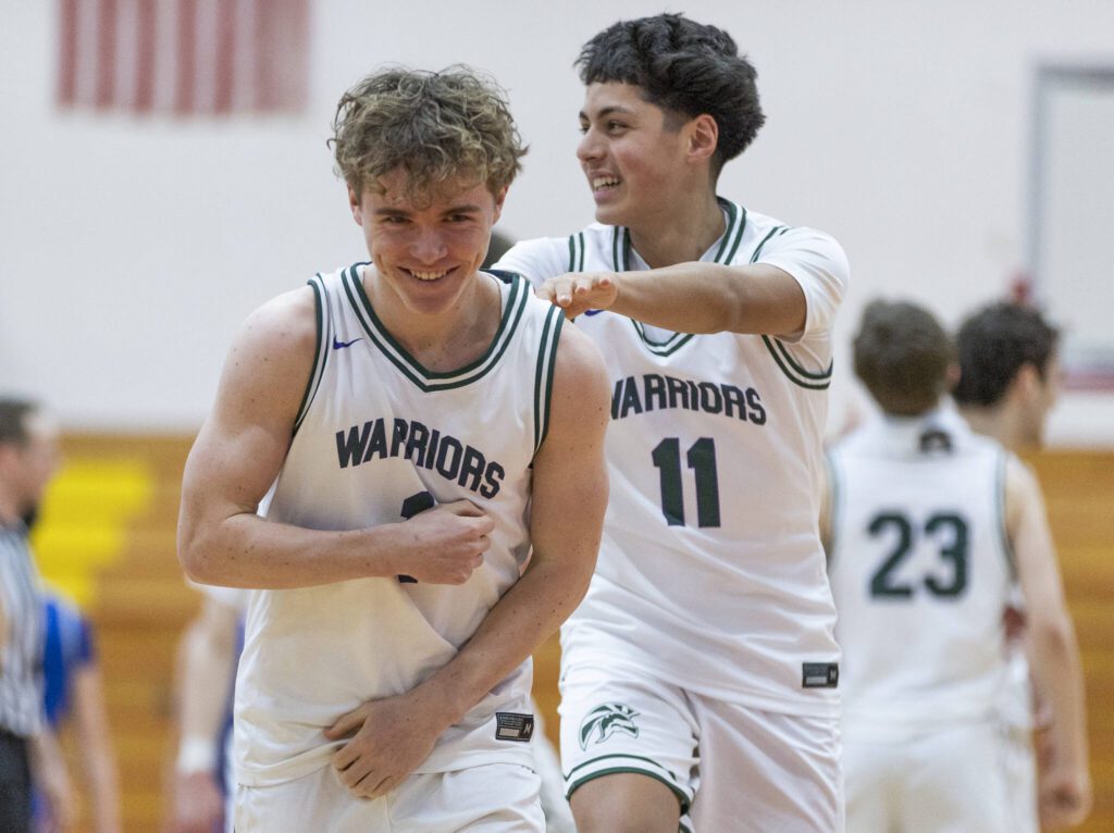 Edmonds-Woodway’s Cavan Schillinger laughs with a teammate during the 3A district semifinal game on Wednesday, Feb. 19, 2025 in Marysville, Washington. (Olivia Vanni / The Herald)
