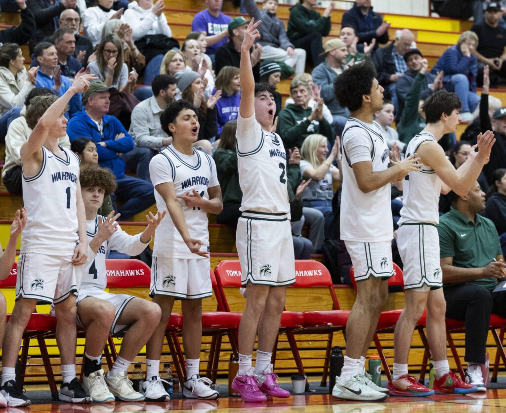 The Edmonds-Woodway bench reacts to a 3-point shot during the 3A district semifinal game against Shorewood on Wednesday, Feb. 19, 2025 in Marysville, Washington. (Olivia Vanni / The Herald)
