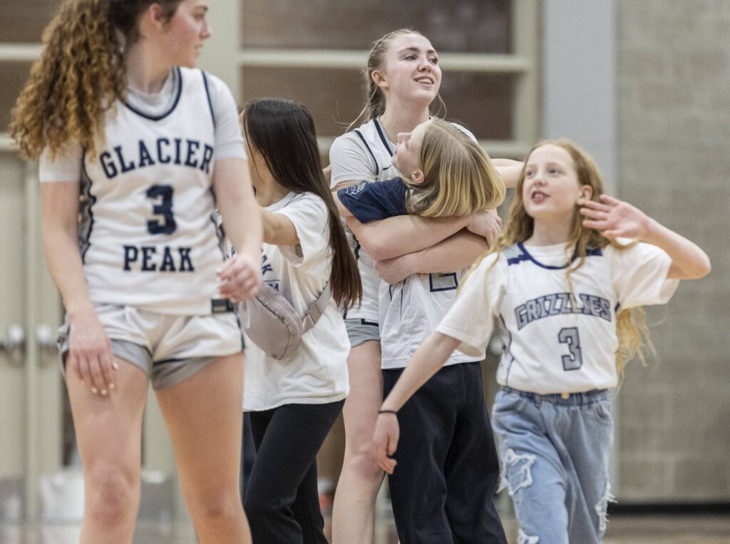 Glacier Peak’s Rikki Miller receives a hug after beating North Creek in the 4A district loser-out playoff game on Thursday, Feb. 20, 2025 in Kirkland, Washington. (Olivia Vanni / The Herald)
