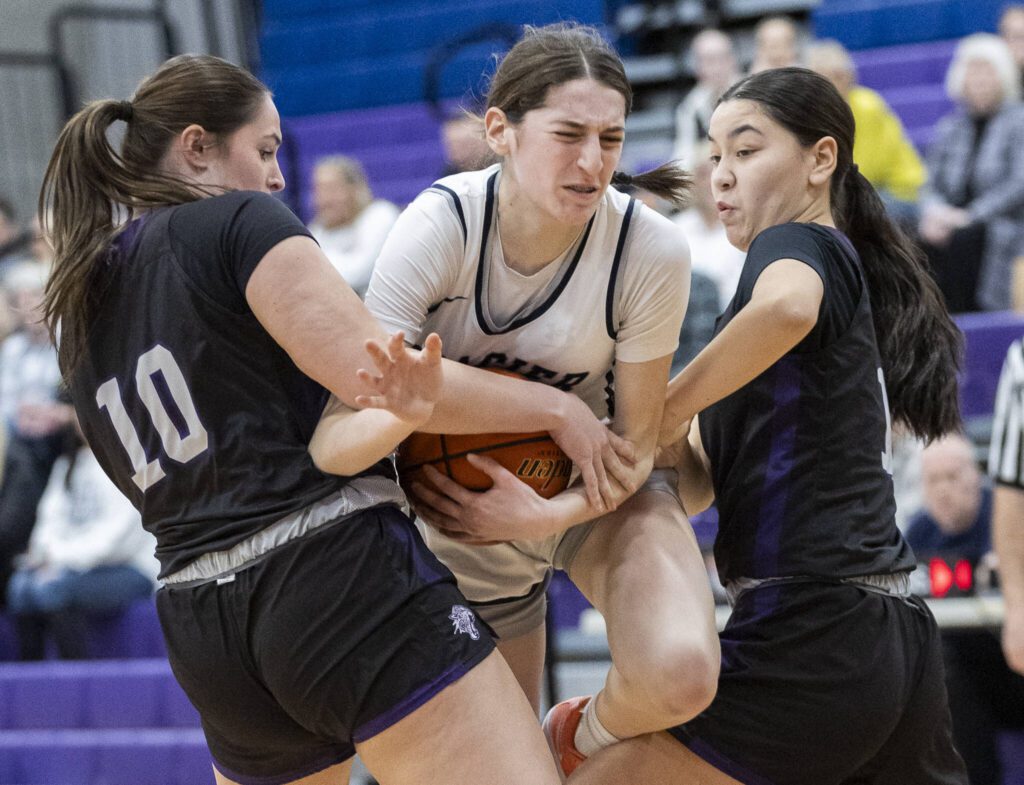 Glacier Peak’s Lillian Riechelson tries to keep possession as two North Creek players reach for the ball during the 4A district loser-out playoff game on Thursday, Feb. 20, 2025 in Kirkland, Washington. (Olivia Vanni / The Herald)
