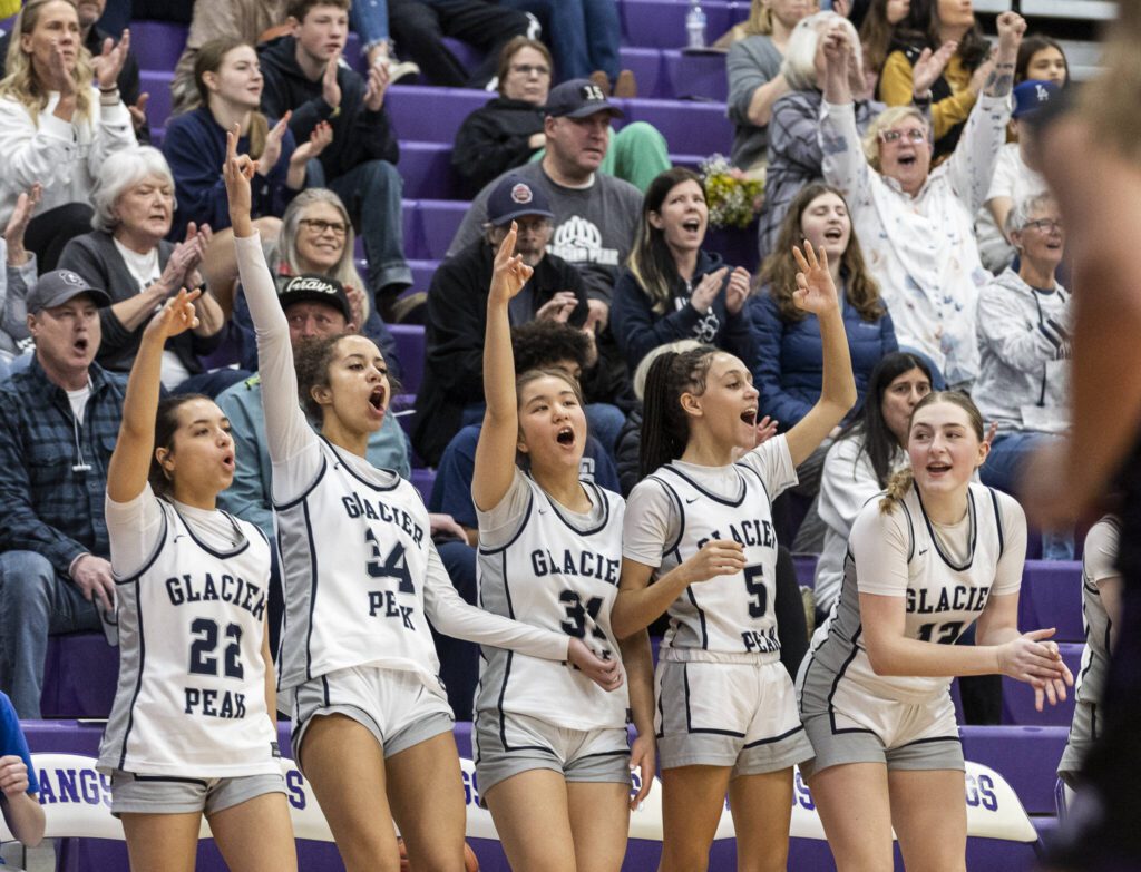 The Glacier Peak bench and fan react to a 3-point shot during the 4A district loser-out playoff game against North Creek on Thursday, Feb. 20, 2025 in Kirkland, Washington. (Olivia Vanni / The Herald)
