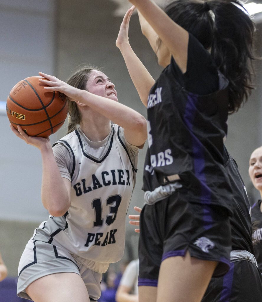 Glacier Peak’s Samantha Thoma tries to make a layup while being guarded and is fouled during the 4A district loser-out playoff game against North Creek on Thursday, Feb. 20, 2025 in Kirkland, Washington. (Olivia Vanni / The Herald)
