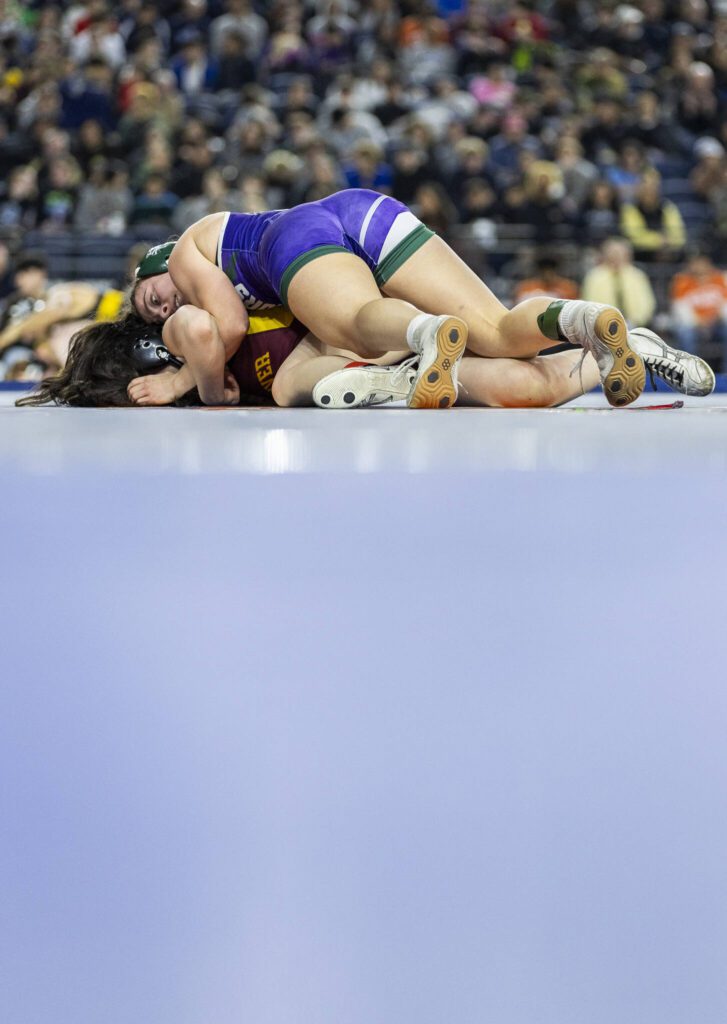 Edmonds-Woodway’s Hannah Baldock gets control of her opponent’s back during the 3A girls 140-pound championship match at the Mat Classic on Friday, Feb. 21, 2025 in Tacoma, Washington. (Olivia Vanni / The Herald)

