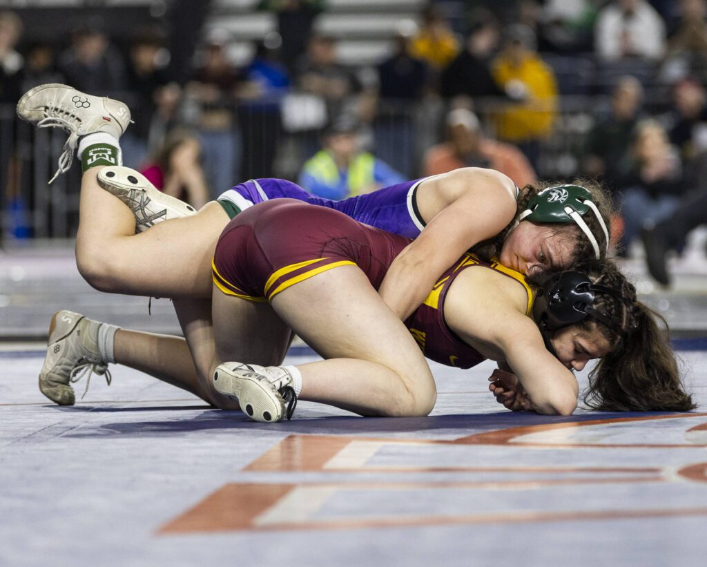 Edmonds-Woodway’s Hannah Baldock gets control of her opponent’s back during the 3A girls 140-pound championship match at the Mat Classic on Friday, Feb. 21, 2025 in Tacoma, Washington. (Olivia Vanni / The Herald)
