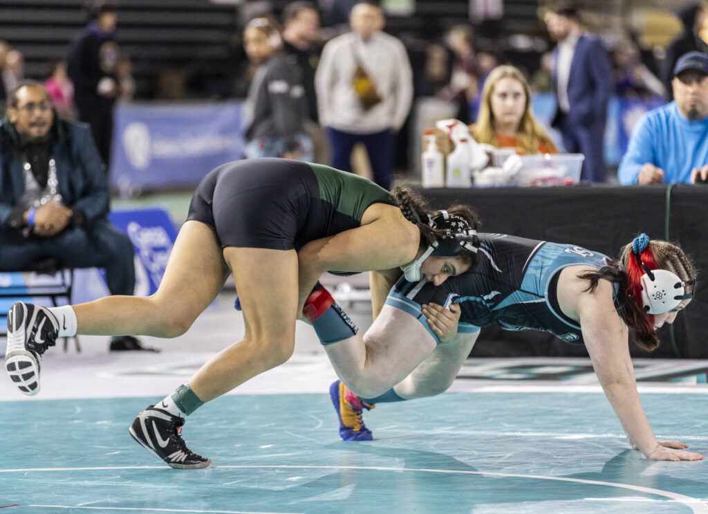 Jackson’s Emily Ortiz Marque gets control of her opponent’s leg during the 4A girls 170-pound championship match at the Mat Classic on Friday, Feb. 21, 2025 in Tacoma, Washington. (Olivia Vanni / The Herald)
