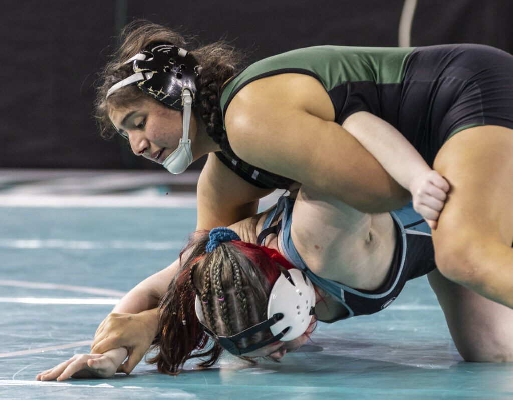 Jackson’s Emily Ortiz Marque has blood drip from her nose as she reaches for her opponent’s wrist during the 4A girls 170-pound championship match at the Mat Classic on Friday, Feb. 21, 2025 in Tacoma, Washington. (Olivia Vanni / The Herald)
