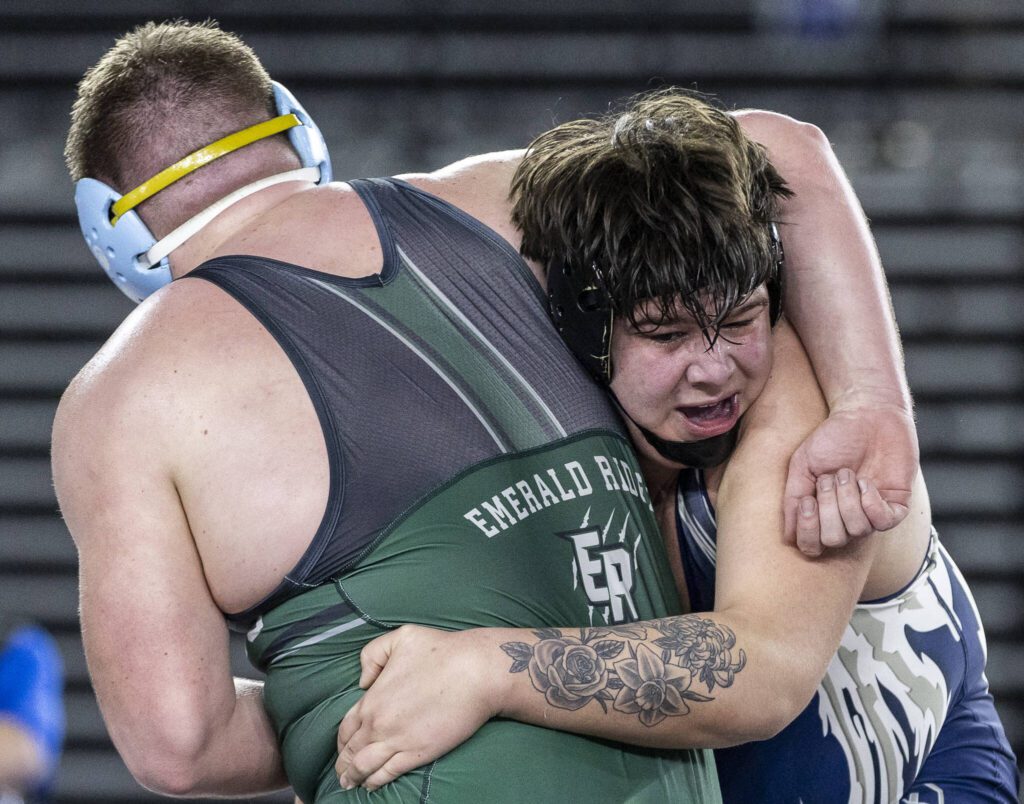 Glacier Peak’s Connor Aney reaches around his opponent’s back during the 4A boys 285-pound championship match at the Mat Classic on Friday, Feb. 21, 2025 in Tacoma, Washington. (Olivia Vanni / The Herald)

