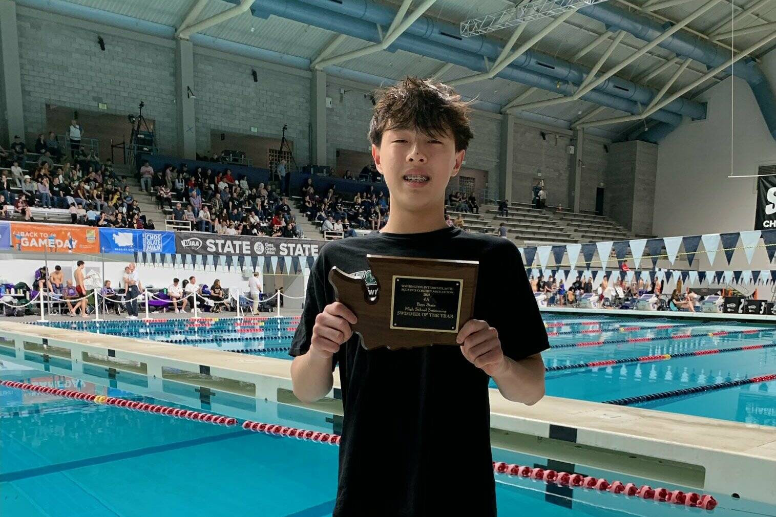 Jackson High School freshman swimmer Syunta Lee holds up the plaque from his second win at the Class 4A state meet at King County Aquatic Center Center on Feb. 22, 2025. (Photo courtesy of Mary Lou Barrett)