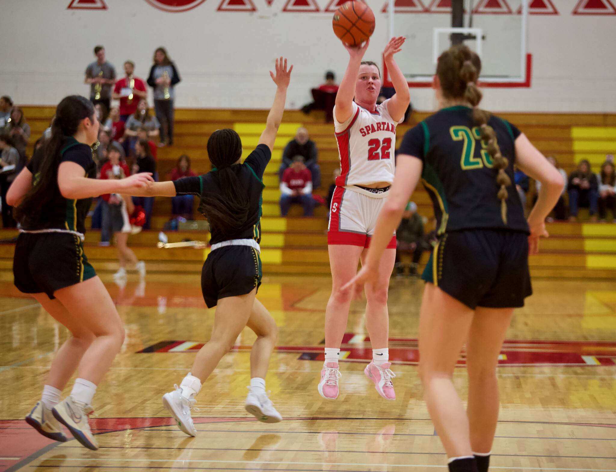 Stanwood senior Jazmyn Legg launches a 3-pointer in the Spartans' 57-49 win against Shorecrest in the District 1 3A Girls Basketball Championship in Marysville, Washington on Feb. 22, 2025. (Joe Pohoryles / The Herald)