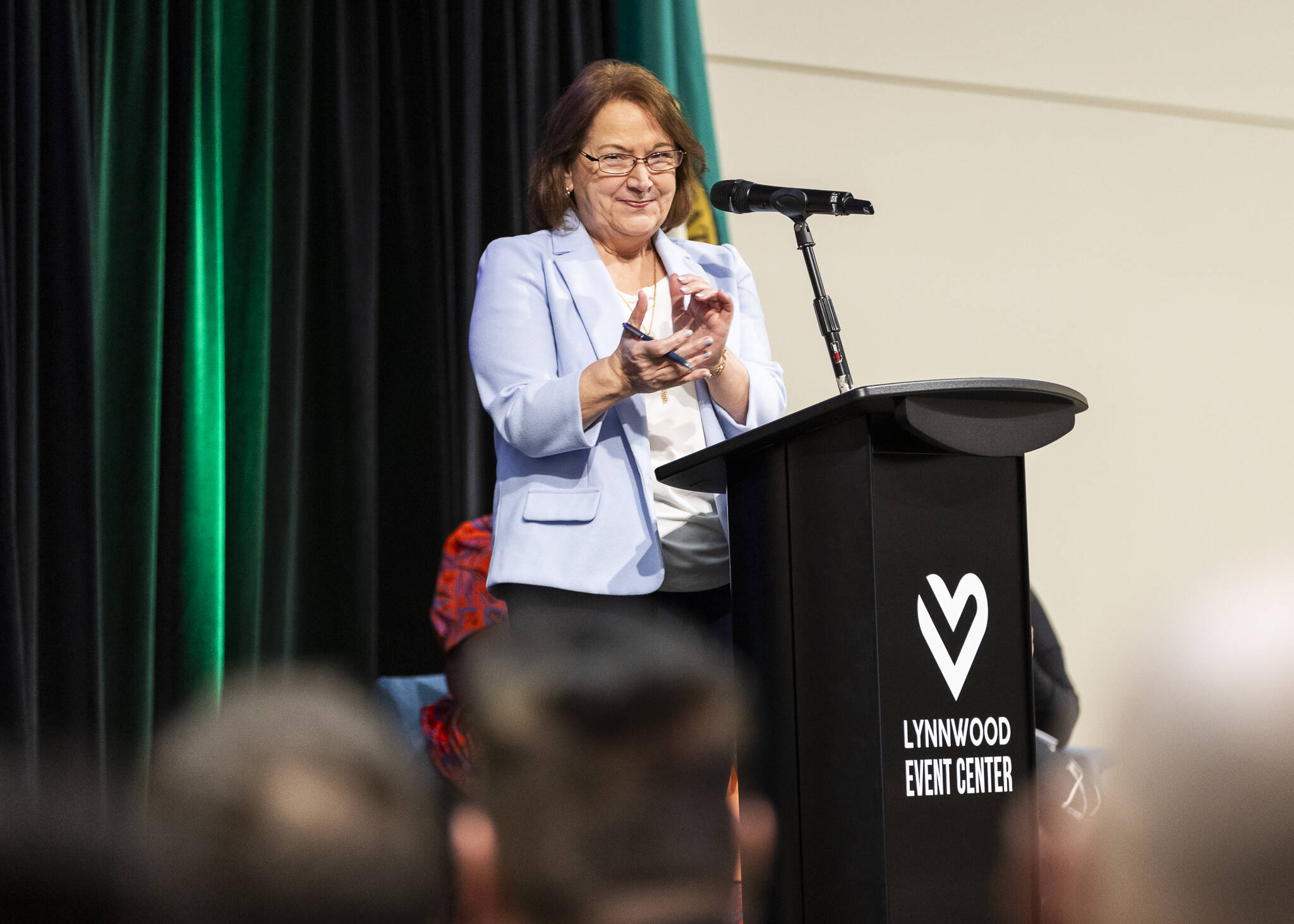 Olivia Vanni / The Herald
Lynnwood Mayor Christine Frizzell claps as she recognizes some of her constituents during her State of the City address at the Lynnwood Event Center on Wednesday in Lynnwood.