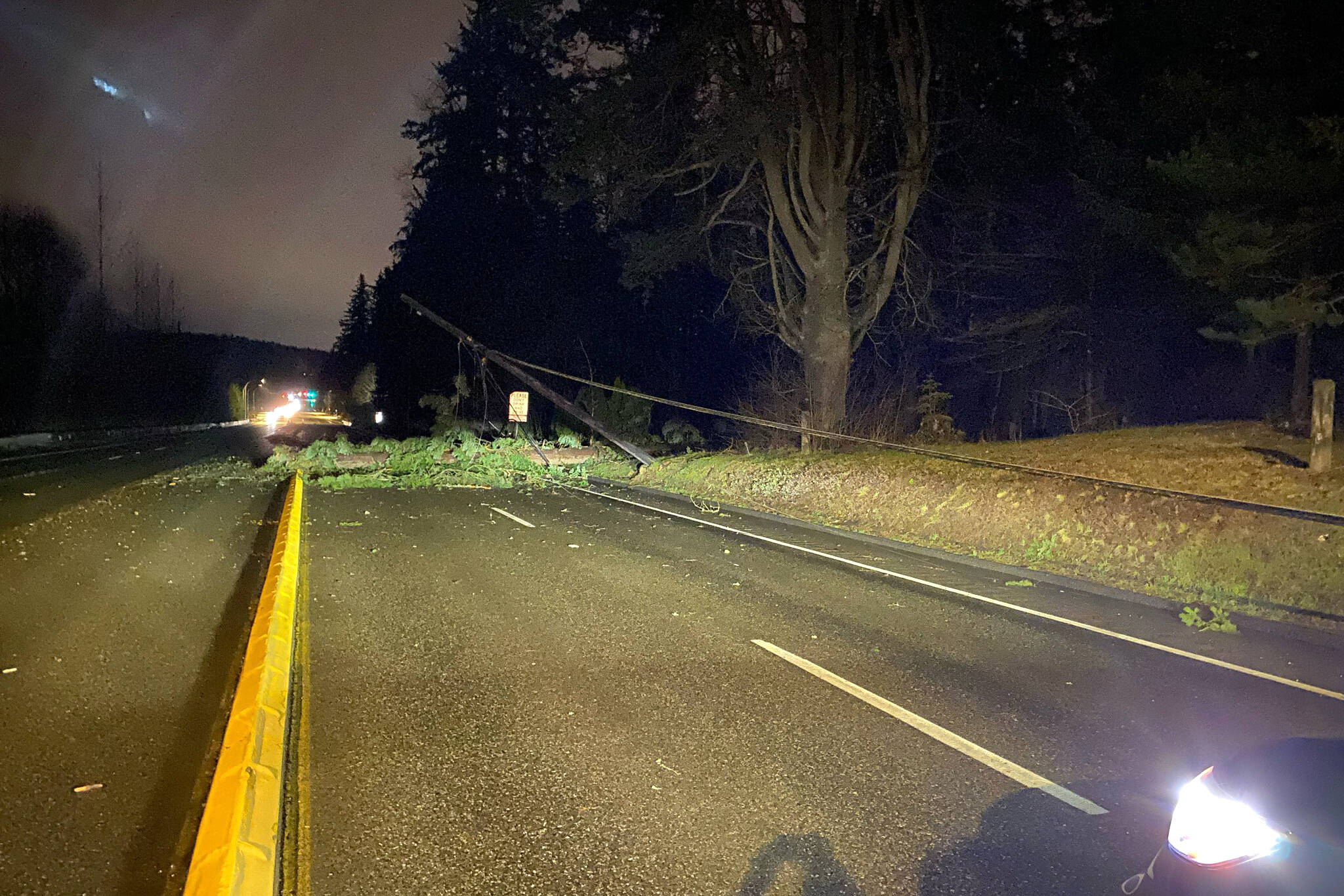 A downed utility pole blocks the southbound lanes of Maltby Road on Monday night. (Washington State Patrol)